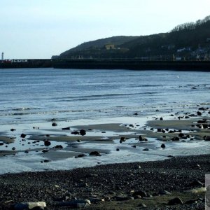 View across the shore to Newlyn's harbour lighthouse