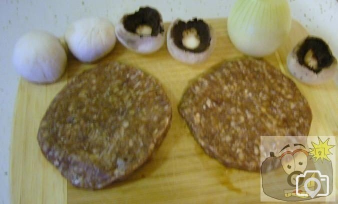Couple of burgers,onion and mushrooms at the ready