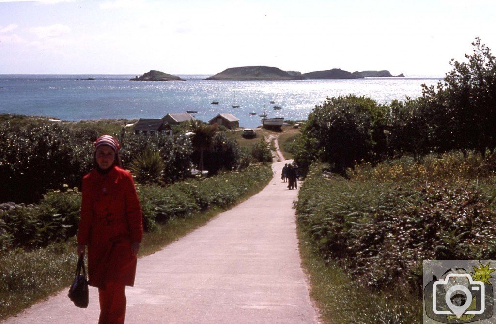Jan climbing the steep hill from the quay, St Martin's, 1977